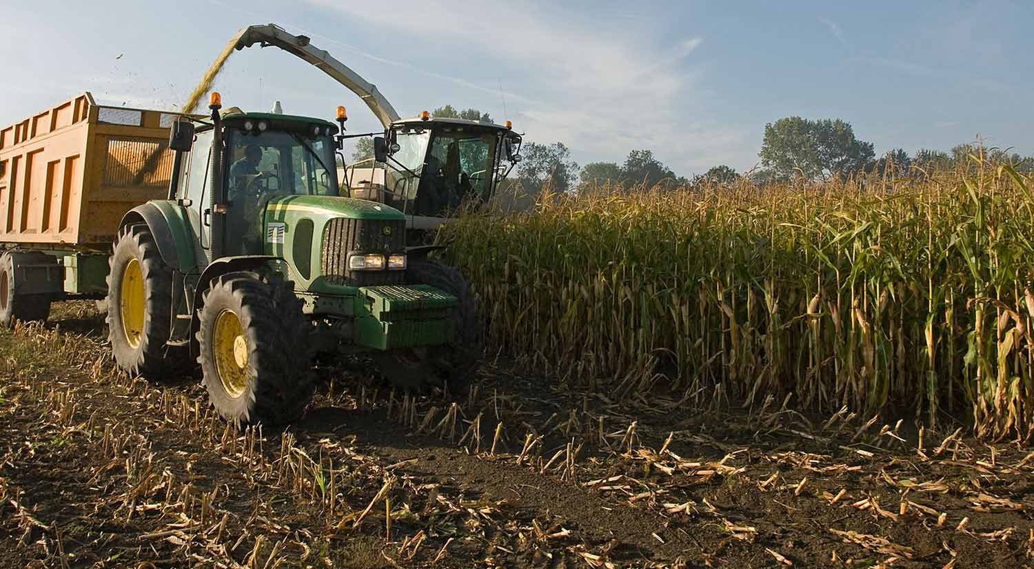 A large farm tractor works in a field